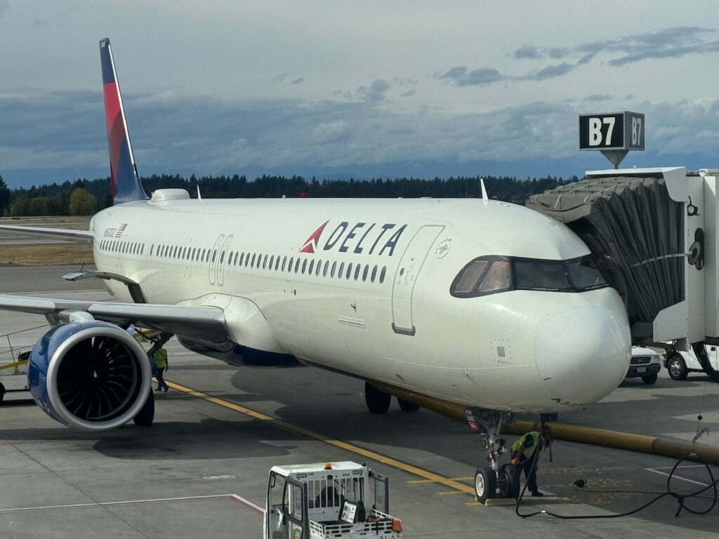 Delta Air Lines Retreats From Two Competitive Domestic Routes a large white airplane on a runway