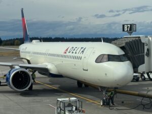 Delta Air Lines Retreats From Two Competitive Domestic Routes a large white airplane on a runway