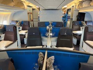 Downgraded From Business Class On An 11-Hour Flight, But Offered Remarkable Compensation a woman standing in a room with blue chairs