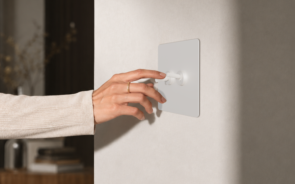 Smart Hotel Technology: upgrading or undermining luxury? hand on repenic switch in hotel guestroom