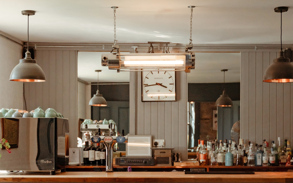 Vintage industrial lighting at scale: Loomlight’s next chapter vintage lighting from Loomlight over retro bar and coffee station photo credit @suiehuntinglodge