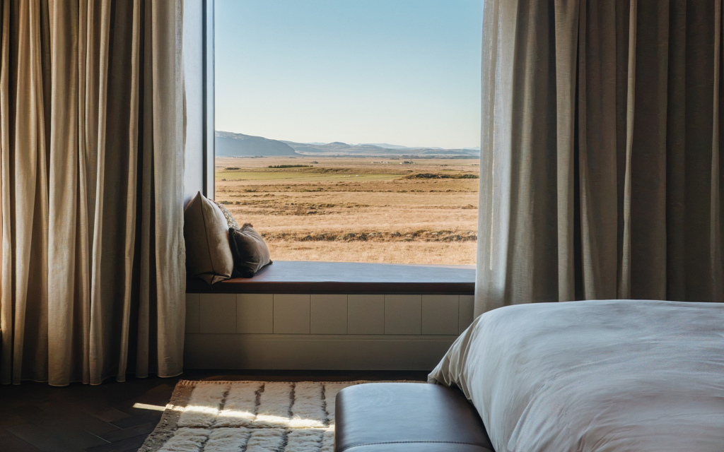 360 Hotel – rooted in Icelandic heritage bed and window seat with panoramic icelandic view in 360 Hotel