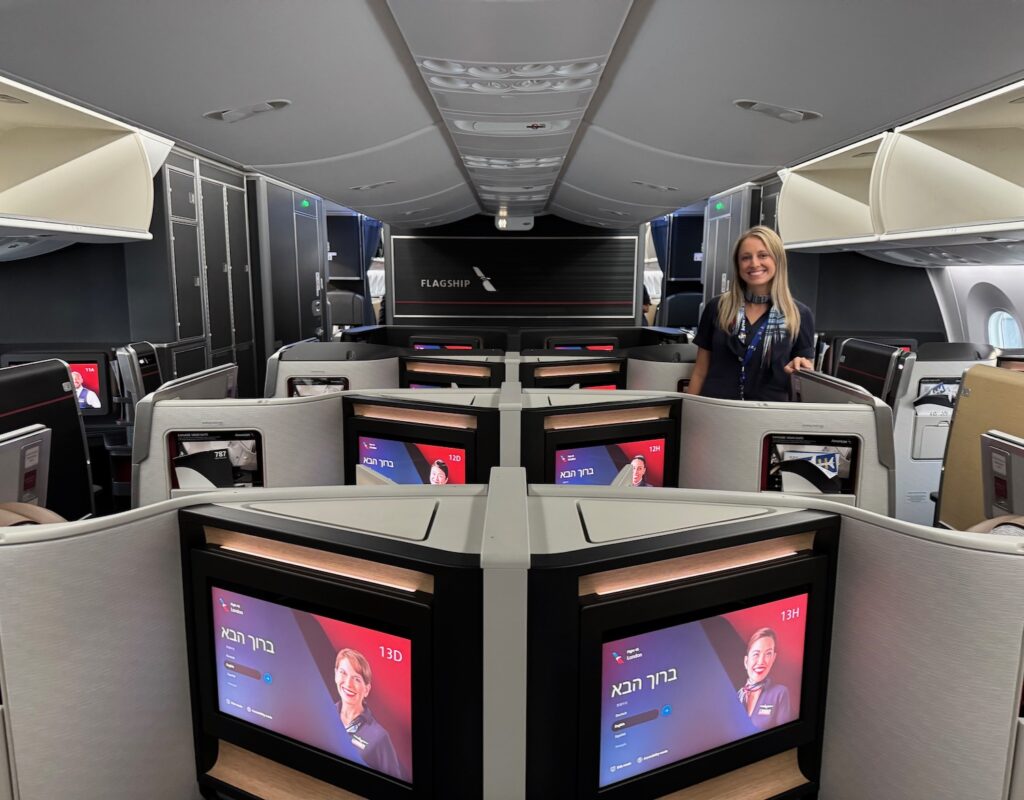 a woman standing in a room with several monitors